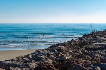 Fototapeta na wymiar Men surfing in the Mediterranean Sea