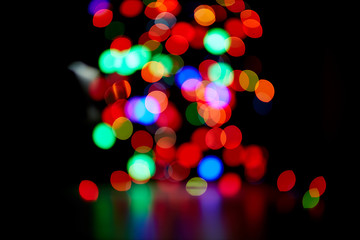 Red and orange, green, blue holliday bokeh. Abstract background