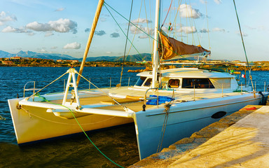 Harbor with Luxury ship at sunset or sunrise and Mediterranean Sea in Old city of Olbia on Sardinia...