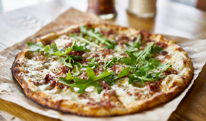 brick oven fired pesto and arugula pizza