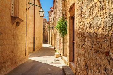 Mediterranean summer cityscape - view of a medieval street in the Old Town of Hvar, on the island of Hvar, the Adriatic coast of Croatia