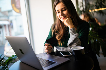 Young pretty woman making video call in cafe