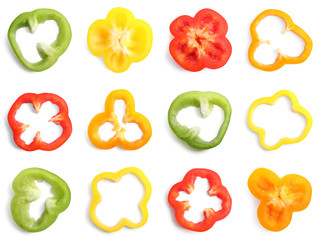 Set of different cut ripe bell peppers on white background, top view