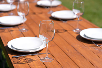 Served wooden table without a tablecloth. Cafe in the open air park
