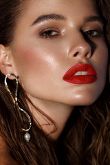 Beautiful sexy girl with bright makeup, red lips, wet hair. Beauty face.