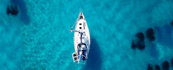 Aerial drone ultra wide photo of sailing yacht docked in paradise turquoise sea exotic island...