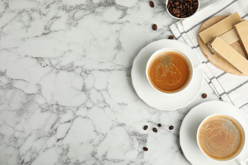 Breakfast with delicious wafers and coffee on white marble table, flat lay. Space for text