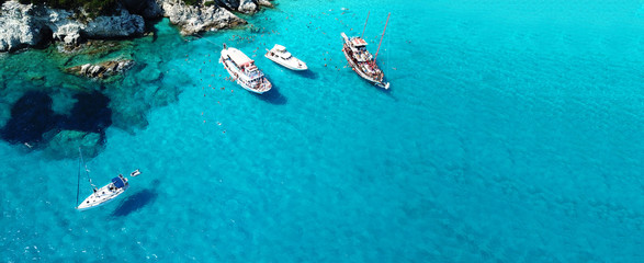 Fototapeta na wymiar Aerial drone ultra wide photo of sailing yacht docked in paradise turquoise sea exotic island destination