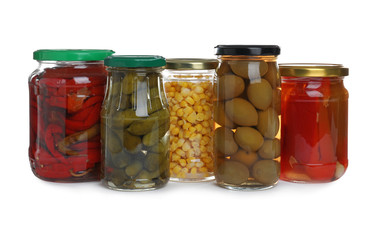 Fototapeta na wymiar Glass jars of different pickled vegetables isolated on white