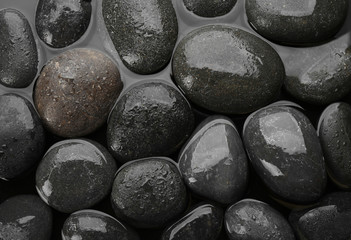 Spa stones in water as background, top view. Zen lifestyle