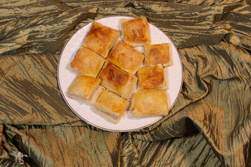 home made pastry on white plate on draped textile background