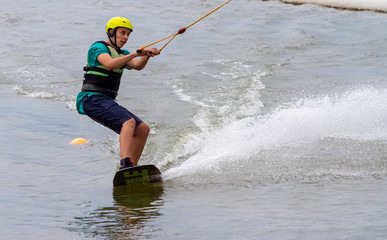 Teenager wakeboarding on a lake - Brwinow, Masovia, Poland