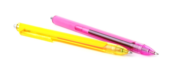 Pink and yellow retractable pens isolated on white