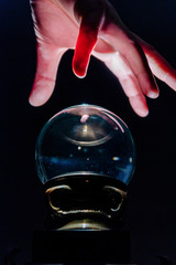 Hand over crystal ball in dark room, crystal ball gazing, crystal ball psychic, crystal ball...
