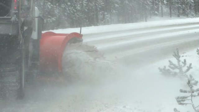 slow motion close up clip of a snow plow clearing part of the grand loop road in yellowstone national park of wyoming, usa
