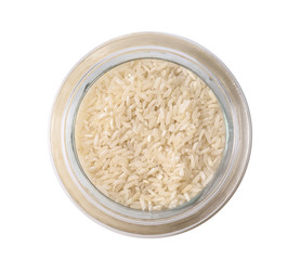 Uncooked rice in glass jar isolated on white, top view