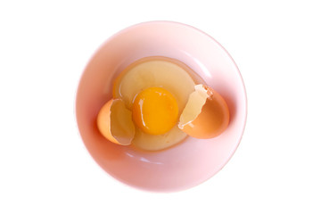 egg shell  and open Eggs in a pink bowl .Top view closeup.