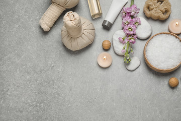Fototapeta na wymiar Flat lay composition with cosmetics on grey marble table, space for text. Spa treatment