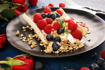 Sweet Homemade Banana Split with yogurt, granola, berries and mint. Banana Split with healthy ingredients