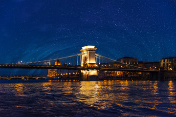 Szechenyi Chain Bridge illuminated by illumination at night in the city of Budapest, Hungary.