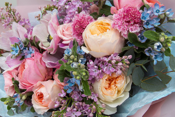 Floral backdrop, background. Flowers in bloom. Yellow pink blue bouquet with roses close-up, details