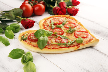 pizza Heart shaped margherita with tomatoes and mozzarella vegetarian. Food concept of romantic love pizza for Valentines Day.