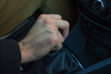 Man hand on gear lever