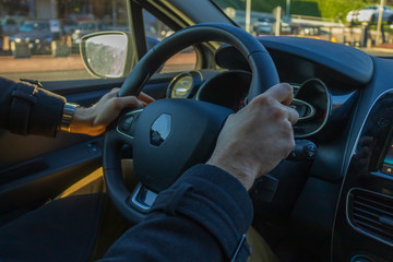 Man holding steering wheel