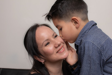 Colombian boy kisses his mom on the cheek on Mother's Day