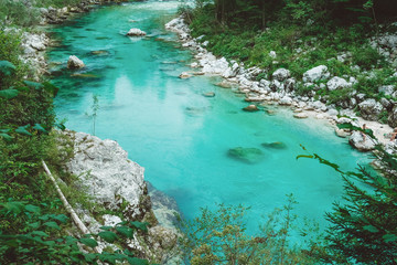 Bright clear blue river surrounded by rocky shores