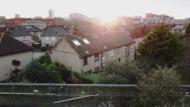 reveal shot of london thames river over the bridge in millwall during sunset