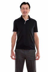 Fototapeta premium Studio shot of happy mature handsome man smiling and standing