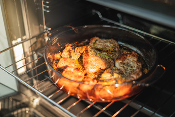 Roasted Pork oven. Housewife prepares roast meat with vegetables in the oven. Cooking in the oven.