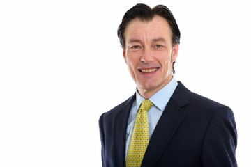 Studio shot of mature happy businessman smiling