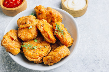 Fried crispy chicken nuggets with french fries and ketchup on light gray background. Seletive focus