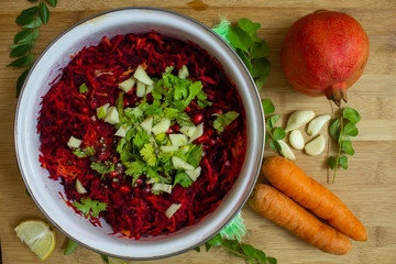 Salad of beetroot, carrot, mango and pomegranate seeds with cilantro topping. Healthy snack rich in antioxidants. Use for health concept.