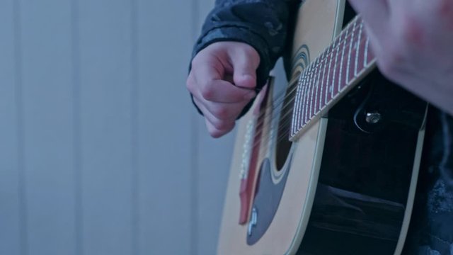 Person Playing New Epiphone Twelve String Acoustic Dreadnought guitar. Slowly moving and orbiting shot.