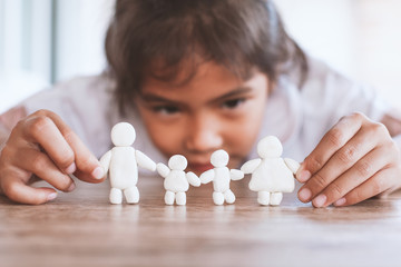 Cute asian child girl playing with plasticine clay happy family with fun. Happy family concept.