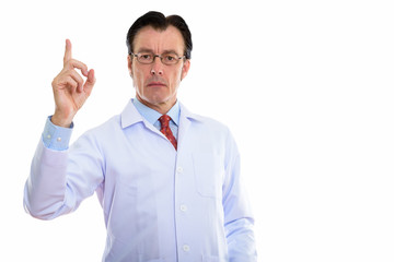 Mature handsome man doctor with eyeglasses pointing up