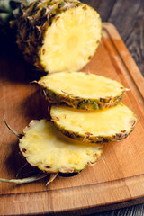 Fresh ripe pineapples on the rustic background. Selective focus.