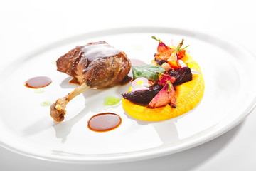 Fried Duck Leg with Young Vegetables, Flowers and Carrot Cream
