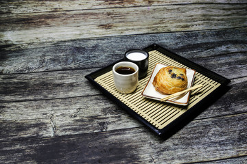 cup of coffee and cake on wooden table
