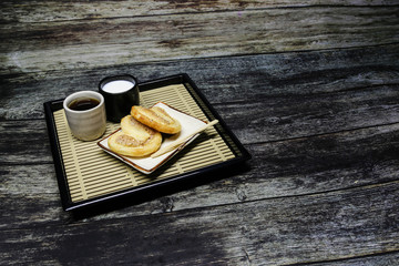 sushi on plate with chopsticks on bamboo mat