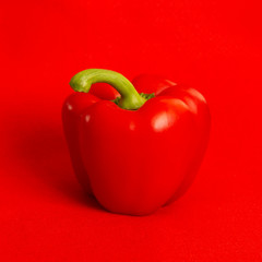 Red sweet bell pepper, paprika on red background