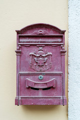 Postbox with a coat of arms in the wall in the Italian town Vernazza of the coastal area Cinque Terre