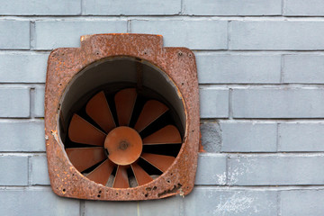 Extractor fan on a brick wall on a commercial building