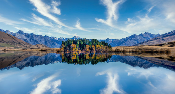 Stunning mountain reflections on the still water in a high country lake in New Zealand - Powered by Adobe