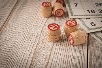 Play bingo or Lotto on a wooden table. Concept of Board games.