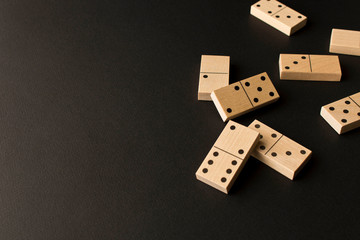 Playing dominoes on a dark background. Leisure games concept. Domino effect. Selective focus.