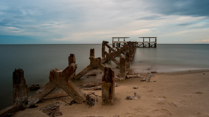Dilapidated old fishing dock collapsing into the sea in Pak Nam Pran Thailand